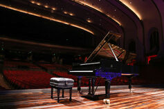 Grand piano sits on the stage of the IU Auditorium.